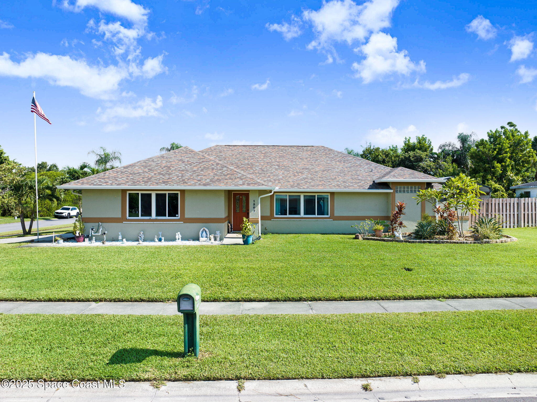 1507 Meadowbrook Road Northeast Palm Bay, FL 32905 - Photo 37 of 50 a front view of a house with a yard