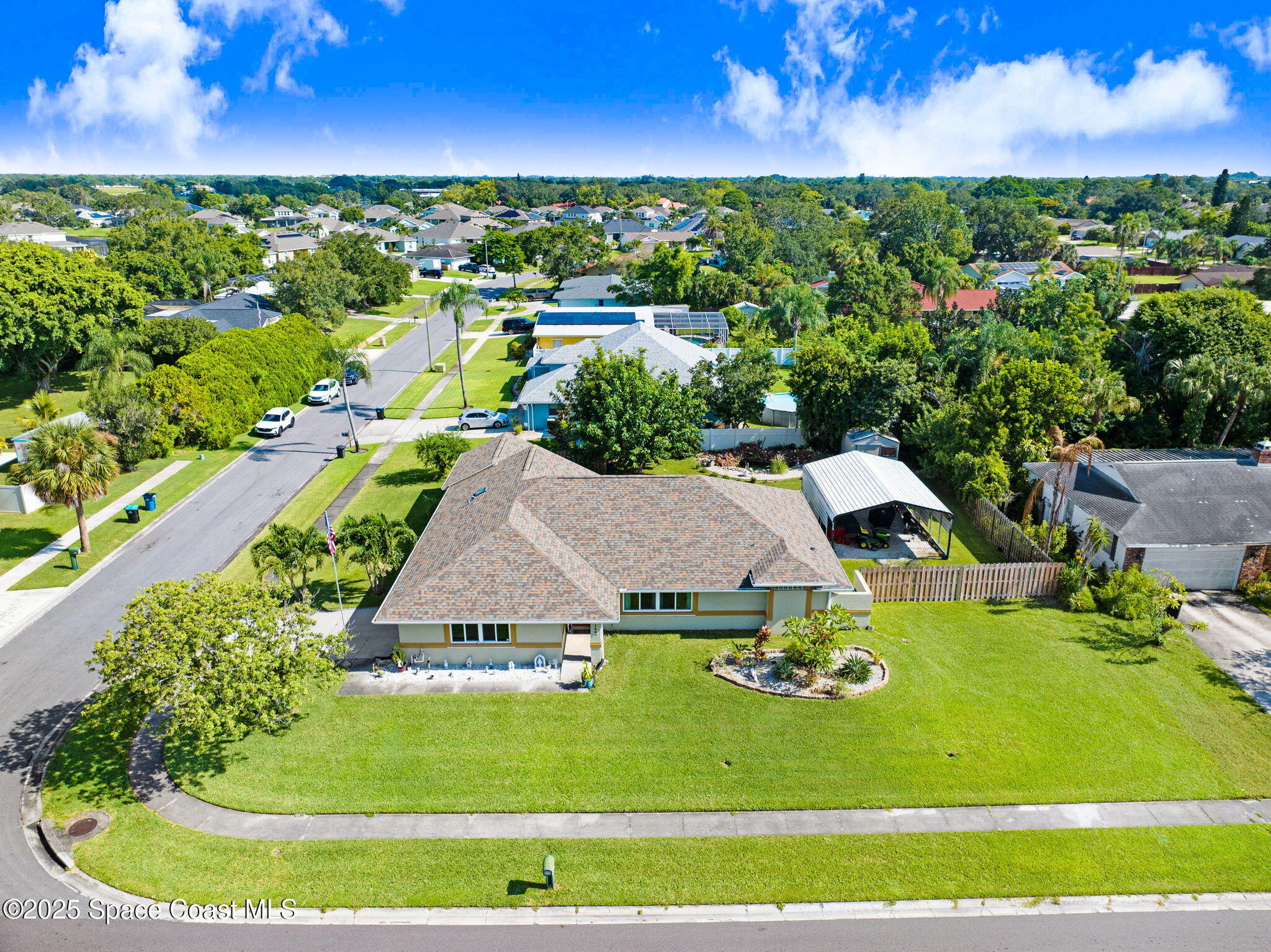 1507 Meadowbrook Road Northeast Palm Bay, FL 32905 - Photo 42 of 50 an aerial view of a house with a yard