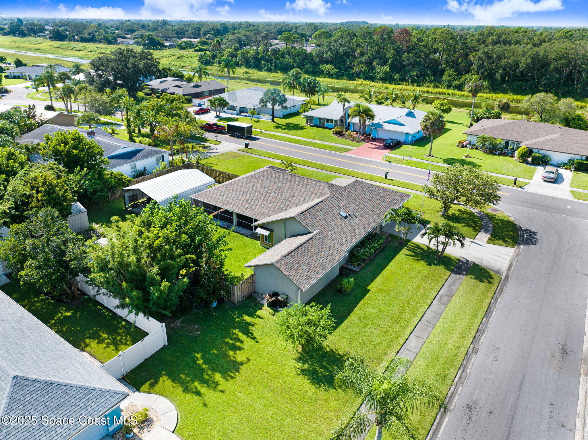 1507 Meadowbrook Road Northeast Palm Bay, FL 32905 - Photo 46 of 50 an aerial view of a house with a swimming pool yard and outdoor seating