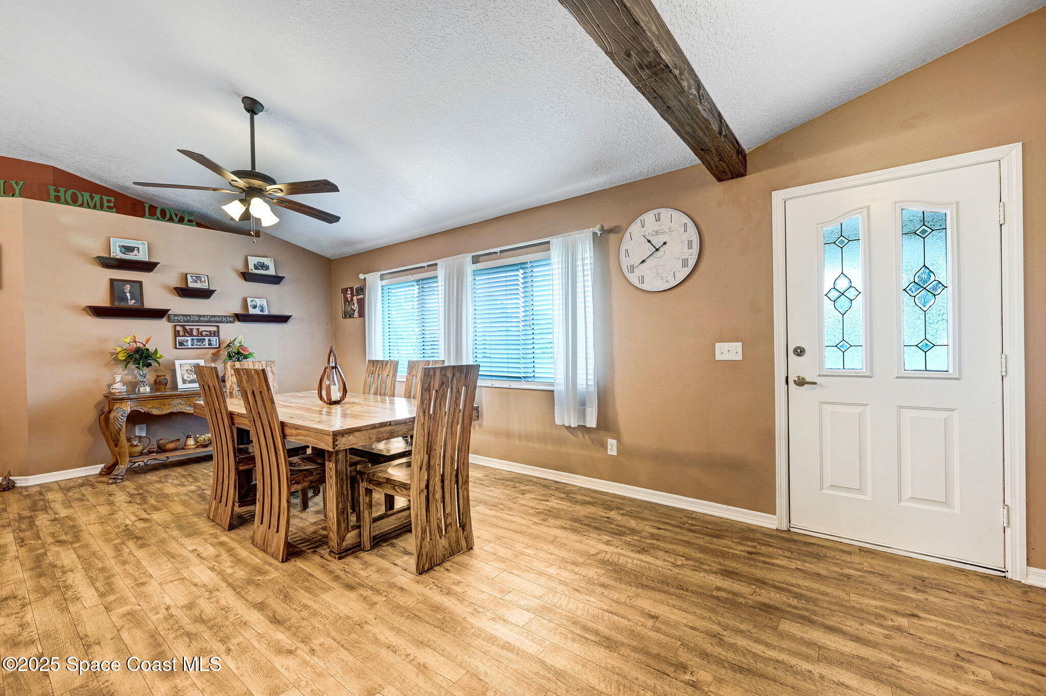 1507 Meadowbrook Road Northeast Palm Bay, FL 32905 - Photo 48 of 50 a view of a dining room with furniture and a chandelier