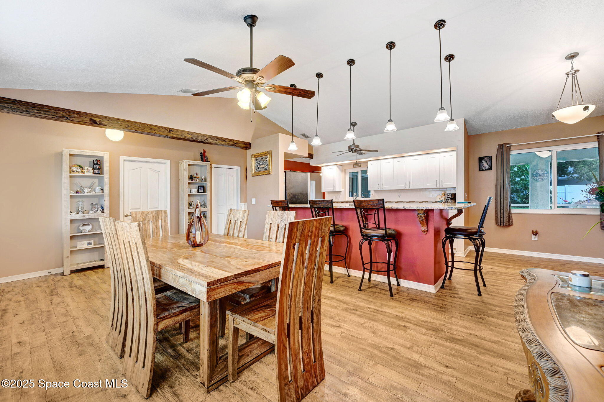 1507 Meadowbrook Road Northeast Palm Bay, FL 32905 - Photo 7 of 50 a dining room with furniture a chandelier and wooden floor