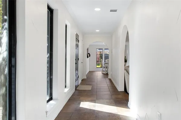 a view of a hallway with wooden floor