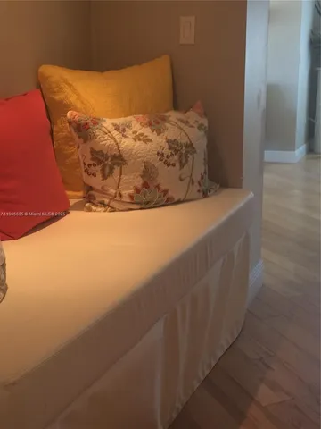 a view of a hallway with wooden floor and entryway