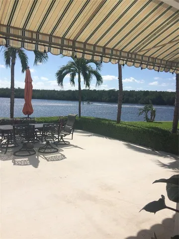 a view of a dinning table and chairs in patio