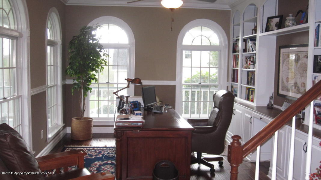 318 Willow Road Pittston, PA 18640 - Photo 3 of 8 a view of a living room with a large windows and wooden floor
