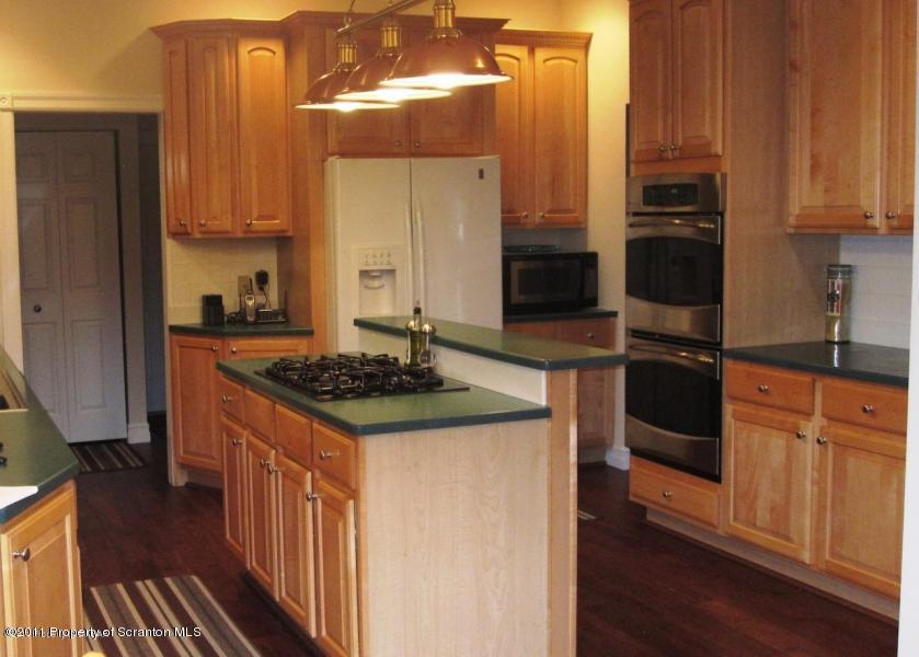 318 Willow Road Pittston, PA 18640 - Photo 8 of 8 a kitchen with stainless steel appliances granite countertop a stove and a refrigerator