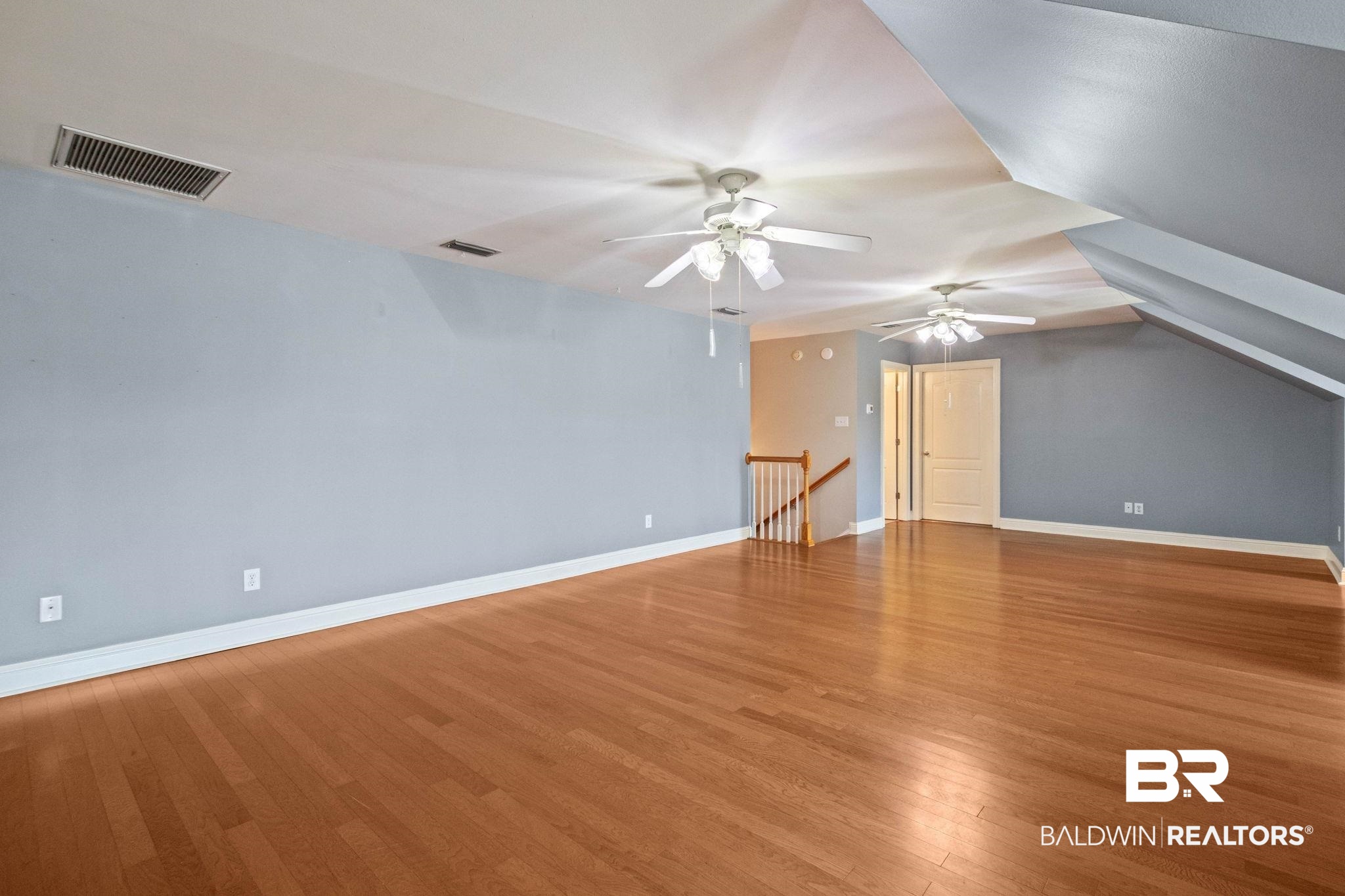 3176 Cedar Court Mobile, AL 36619 - Photo 29 of 33 Expansive room featuring wood-finish flooring and multiple ceiling fans