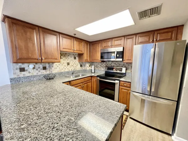 a bedroom with a large bed and a flat tv screen