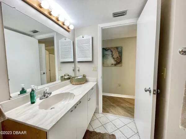 a view of hallway with a door and wooden floor