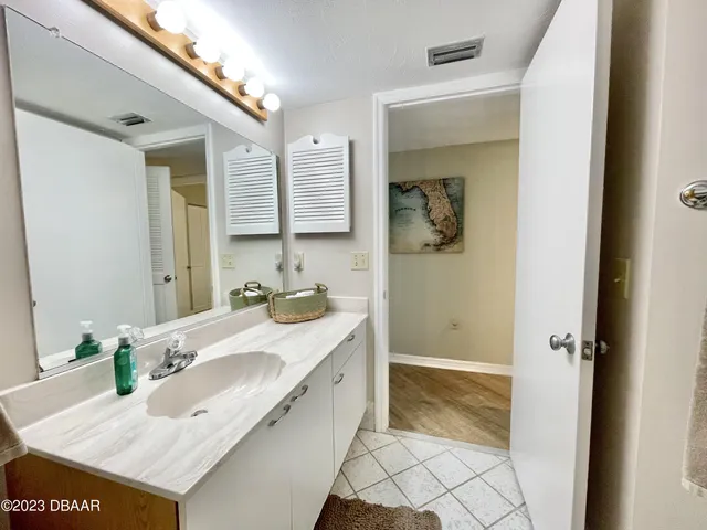 a view of hallway with a door and wooden floor