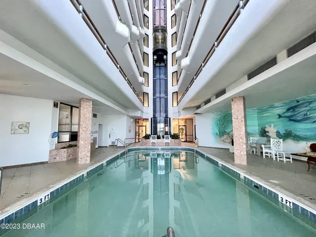 a view of a swimming pool and an outdoor seating