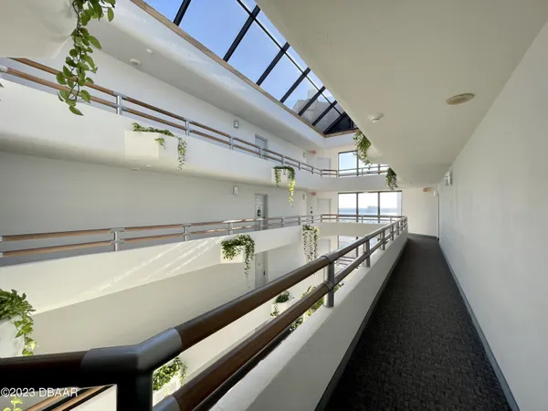 a living room with furniture a lamp and a potted plant