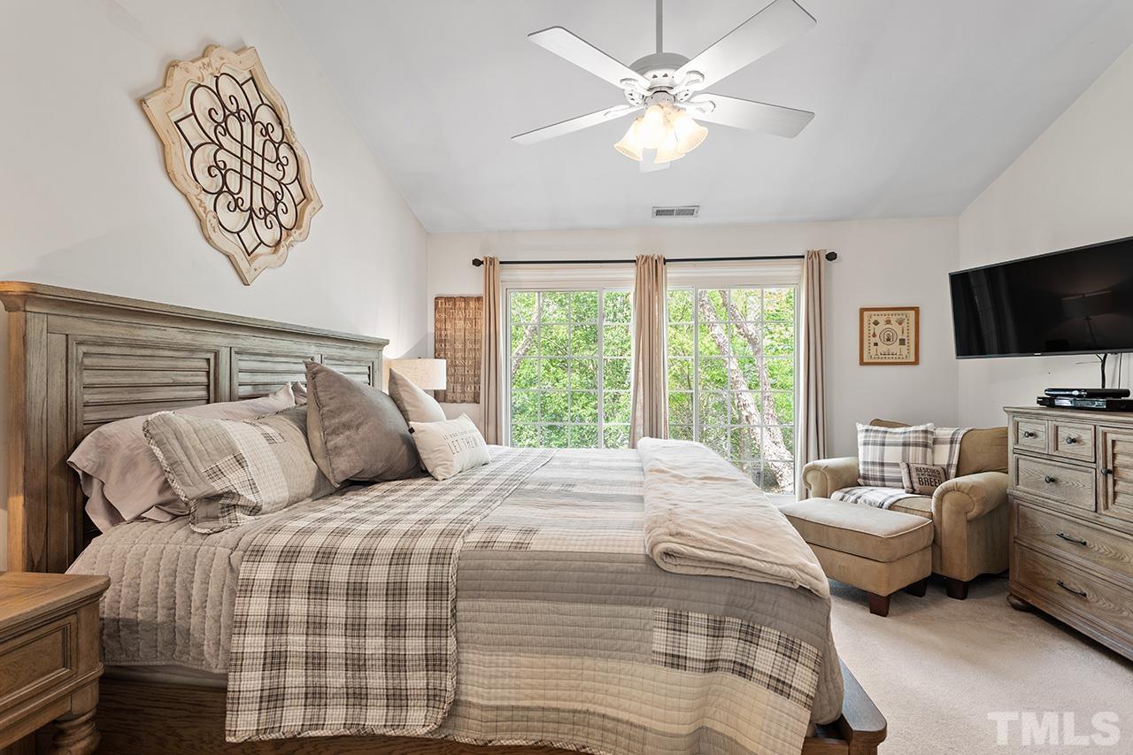 9529 Miranda Drive Raleigh, NC 27617 - Photo 18 of 39 Beautiful natural light and a treehouse-like feel in warmer months brings the outdoors in to the primary suite, and the mature trees offer privacy without drawing the curtains!