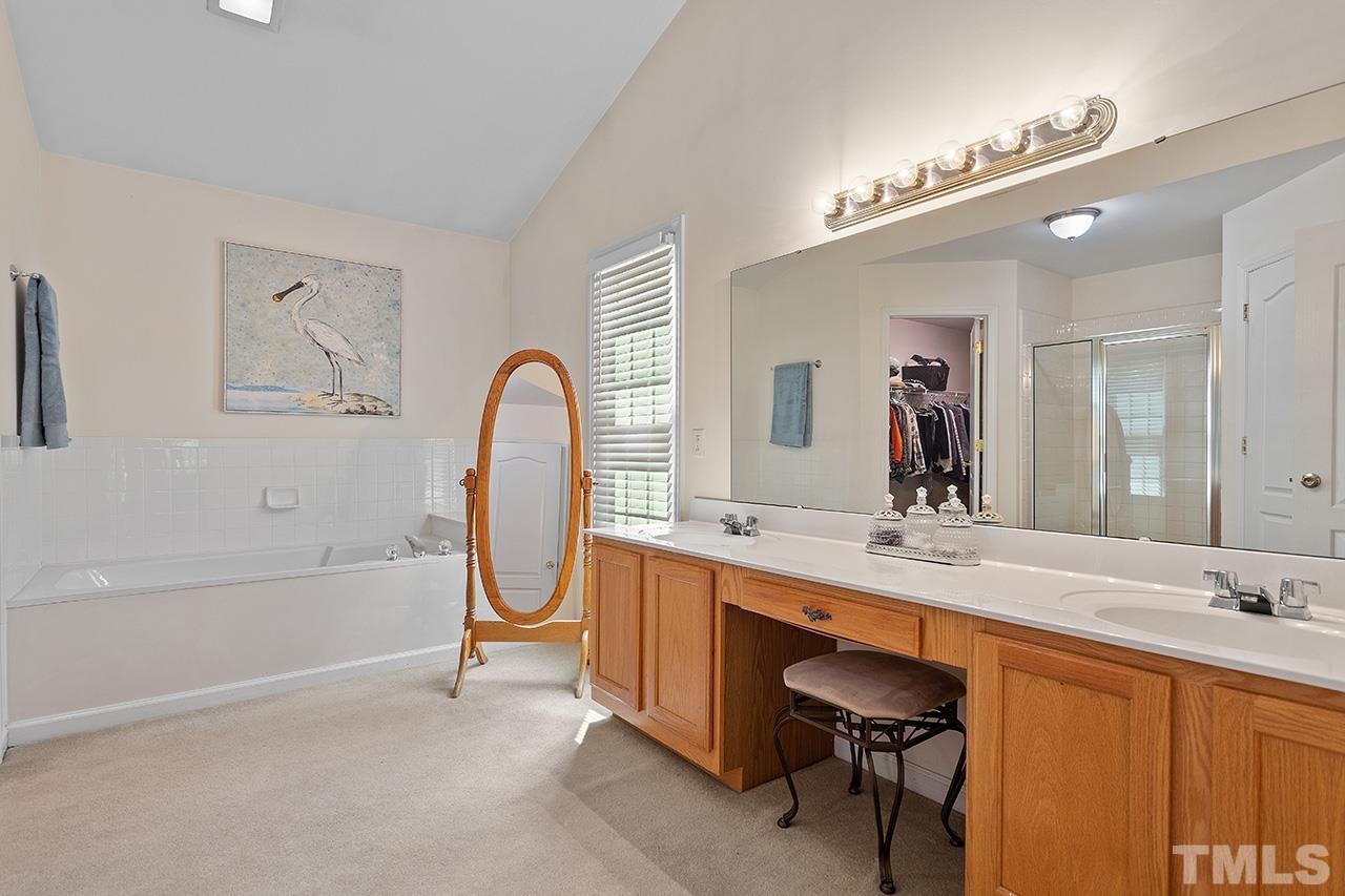 9529 Miranda Drive Raleigh, NC 27617 - Photo 19 of 39 The primary suite bathroom is just enormous, and includes a large soaking tub and double vanity, plus separate walk-in shower