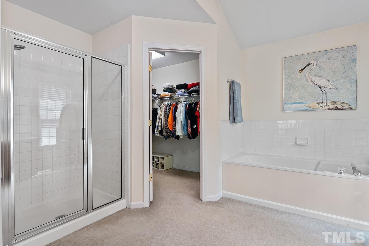 9529 Miranda Drive Raleigh, NC 27617 - Photo 20 of 39 The spacious primary bath features a walk-in shower and generous closet as well as private w/c.