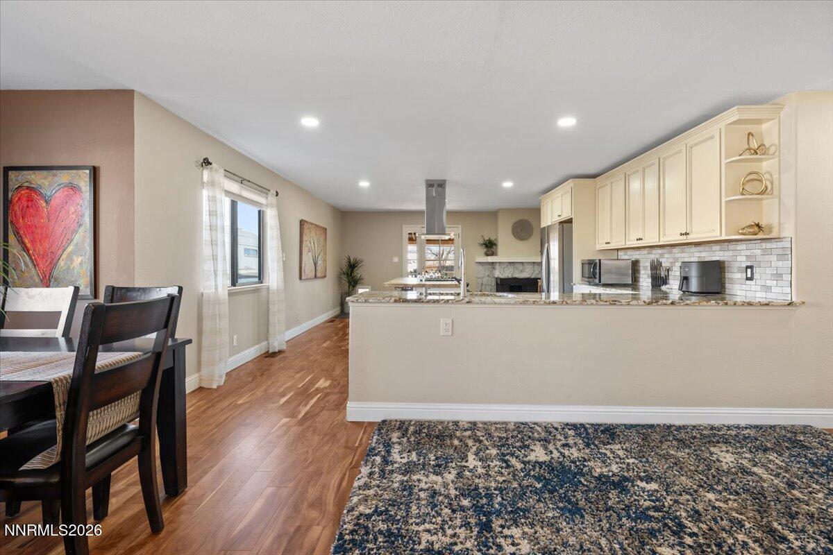 2224 Escalera Way Reno, NV 89523 - Photo 13 of 44 a living room with stainless steel appliances kitchen island granite countertop furniture and wooden floor