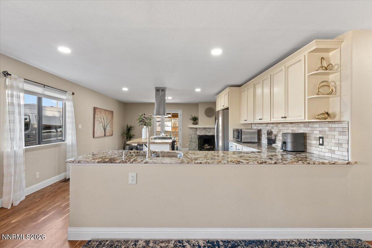 2224 Escalera Way Reno, NV 89523 - Photo 14 of 44 a large white kitchen with stainless steel appliances kitchen island granite countertop a stove and white cabinets