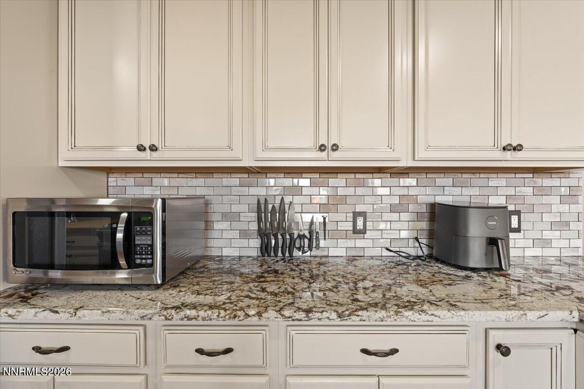 2224 Escalera Way Reno, NV 89523 - Photo 21 of 44 a kitchen with granite countertop white cabinets and white appliances