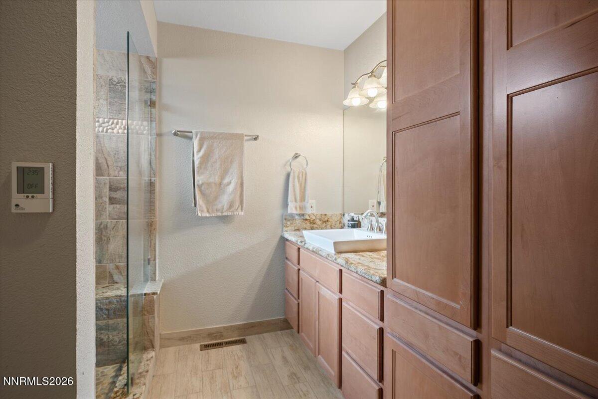 2224 Escalera Way Reno, NV 89523 - Photo 26 of 44 a bathroom with a shower sink and mirror