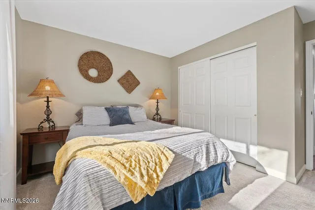 a bedroom with a bed and lamp