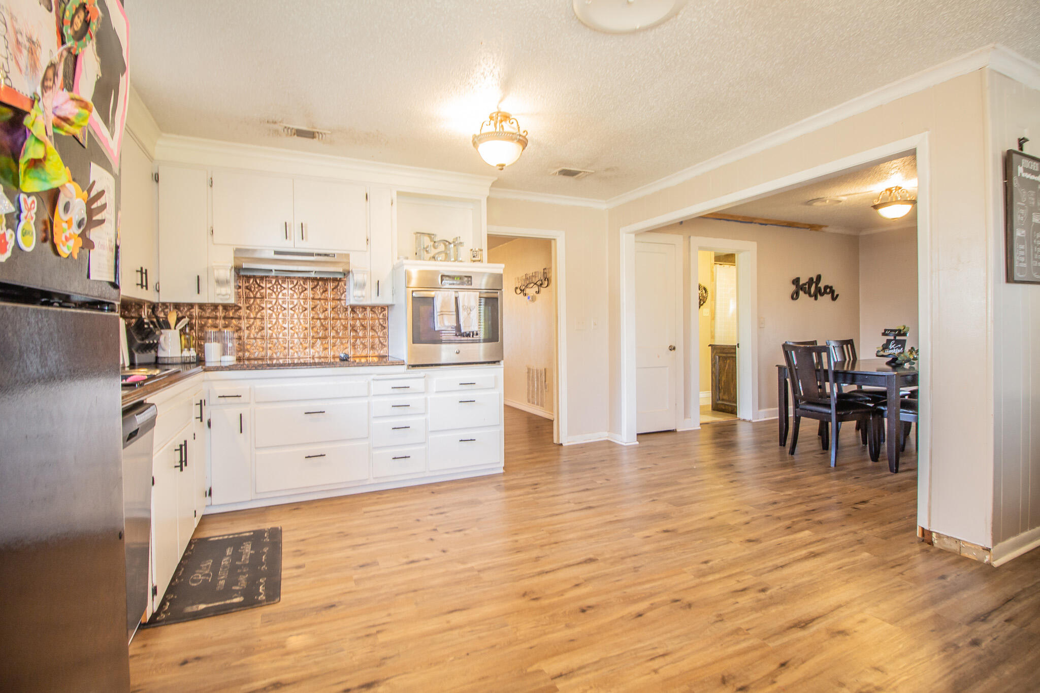 907 Ave H Hale Center, TX 79041 - Photo 12 of 32 a view of kitchen with furniture and wooden floor
