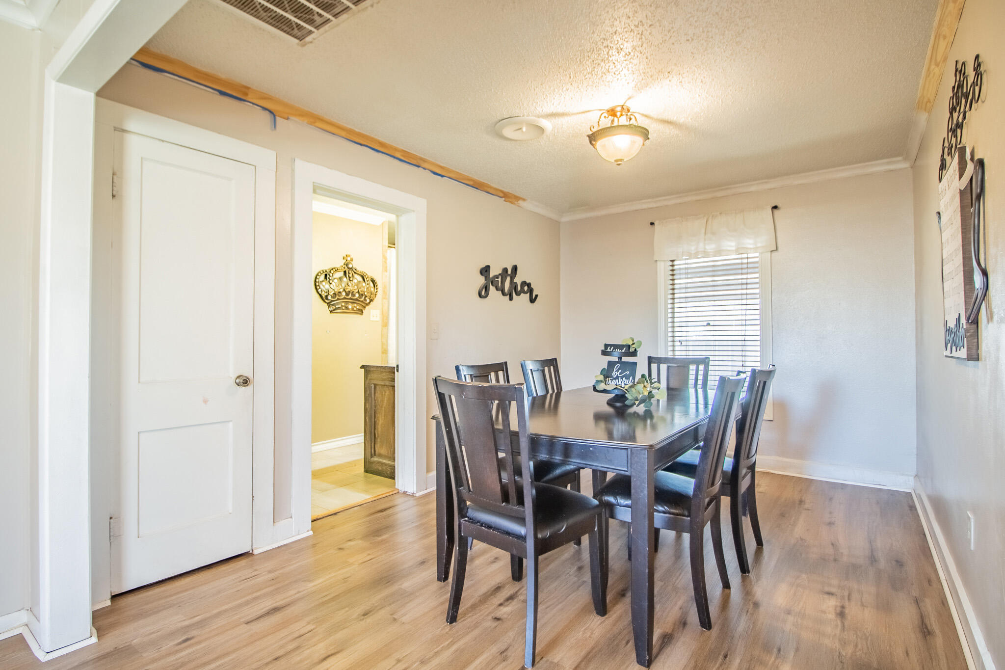 907 Ave H Hale Center, TX 79041 - Photo 15 of 32 a view of a dining room with furniture and wooden floor