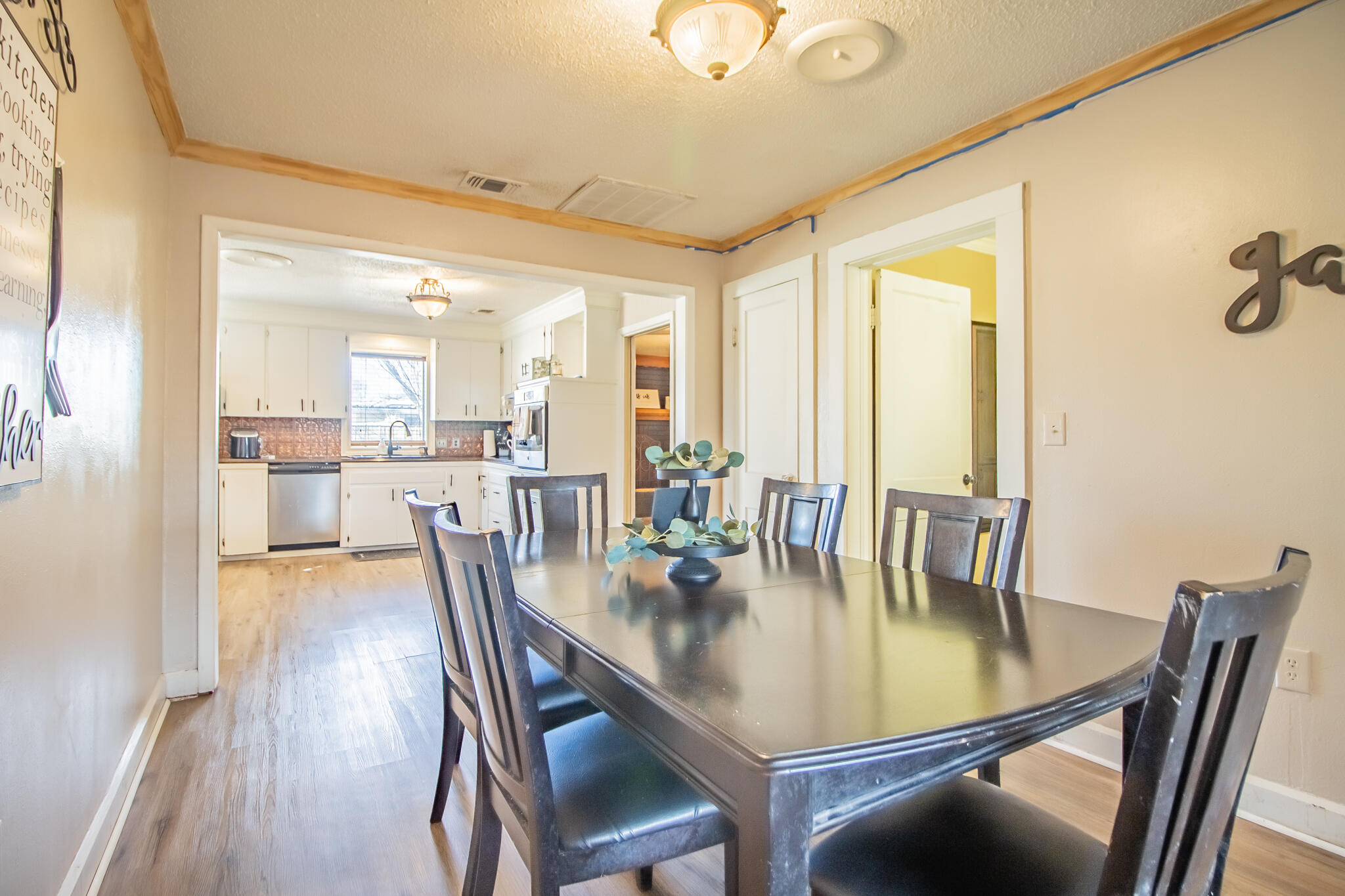 907 Ave H Hale Center, TX 79041 - Photo 16 of 32 a dining room with furniture a chandelier and wooden floor