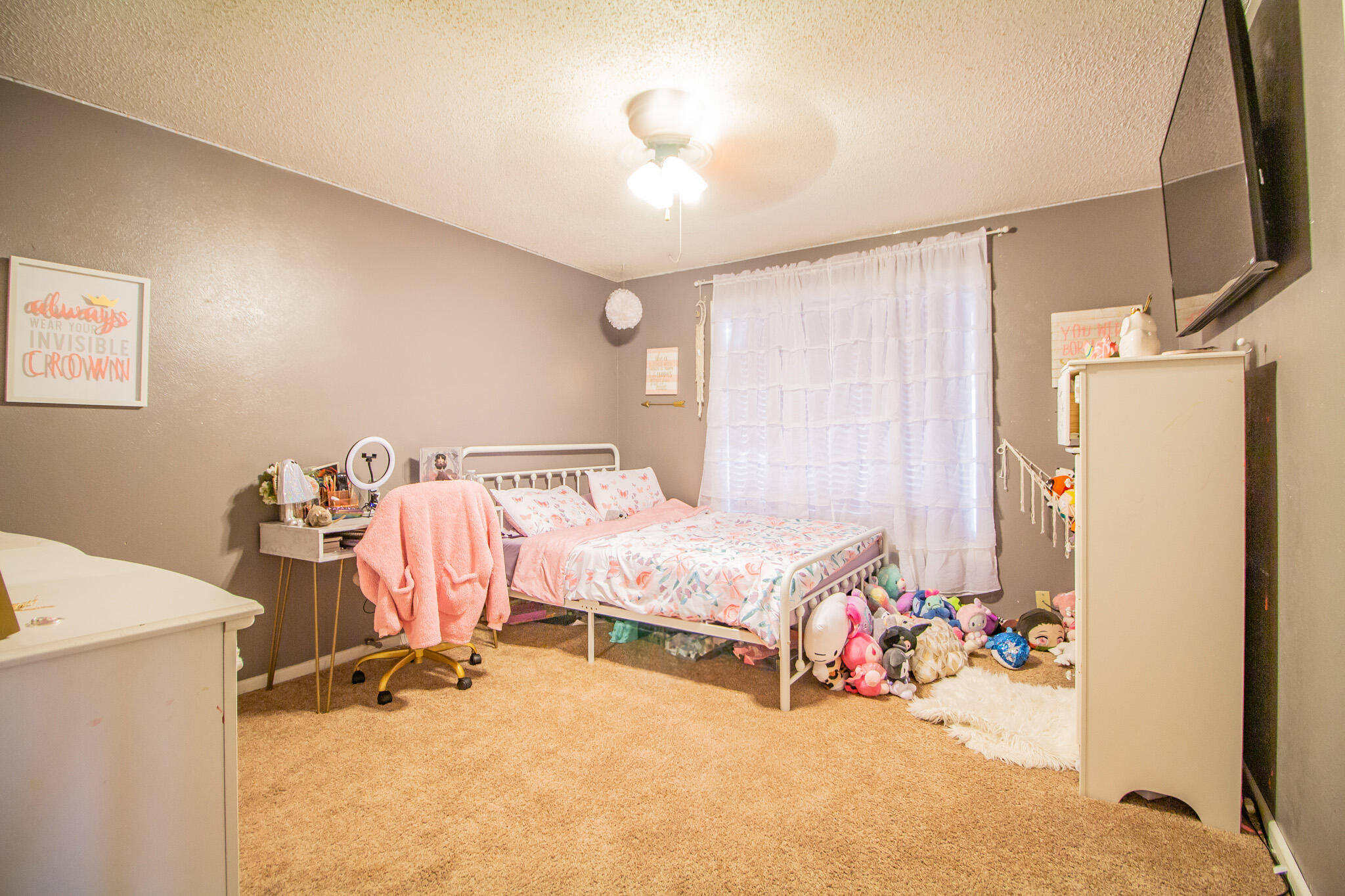 907 Ave H Hale Center, TX 79041 - Photo 21 of 32 a bedroom with a bed and a chandelier