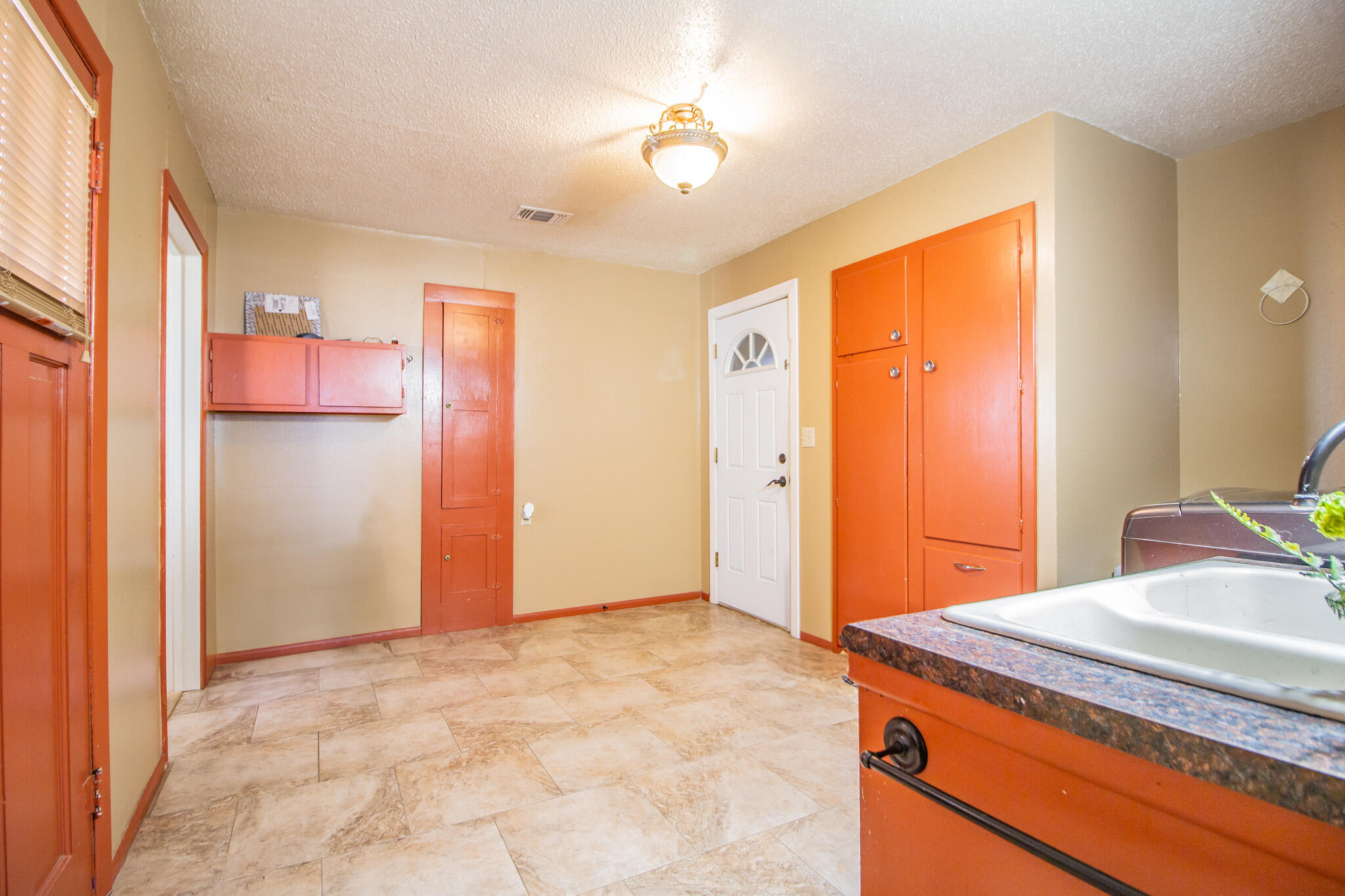 907 Ave H Hale Center, TX 79041 - Photo 26 of 32 a bathroom with a granite countertop sink and a mirror