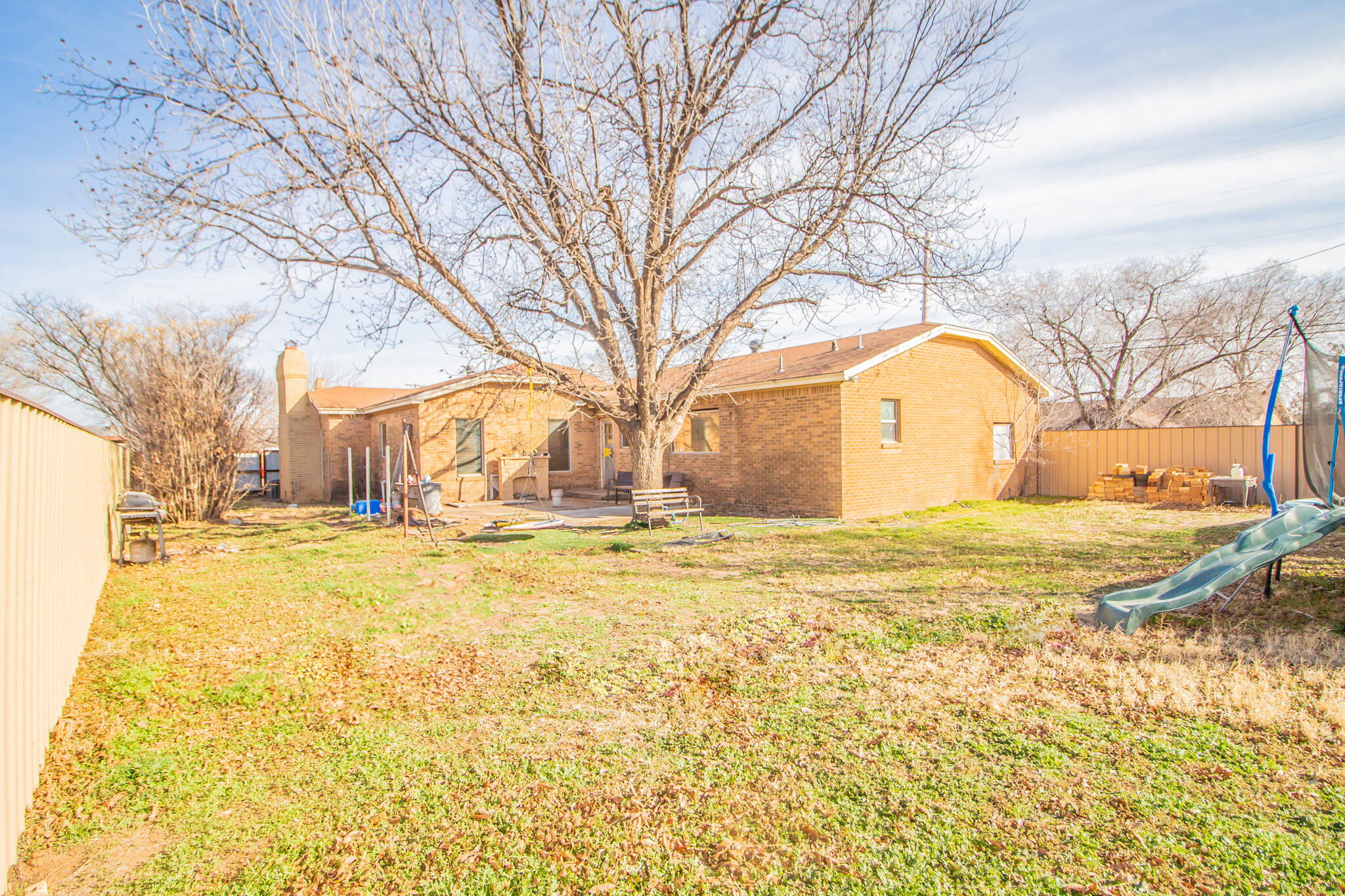 907 Ave H Hale Center, TX 79041 - Photo 30 of 32 a view of a yard with a large tree