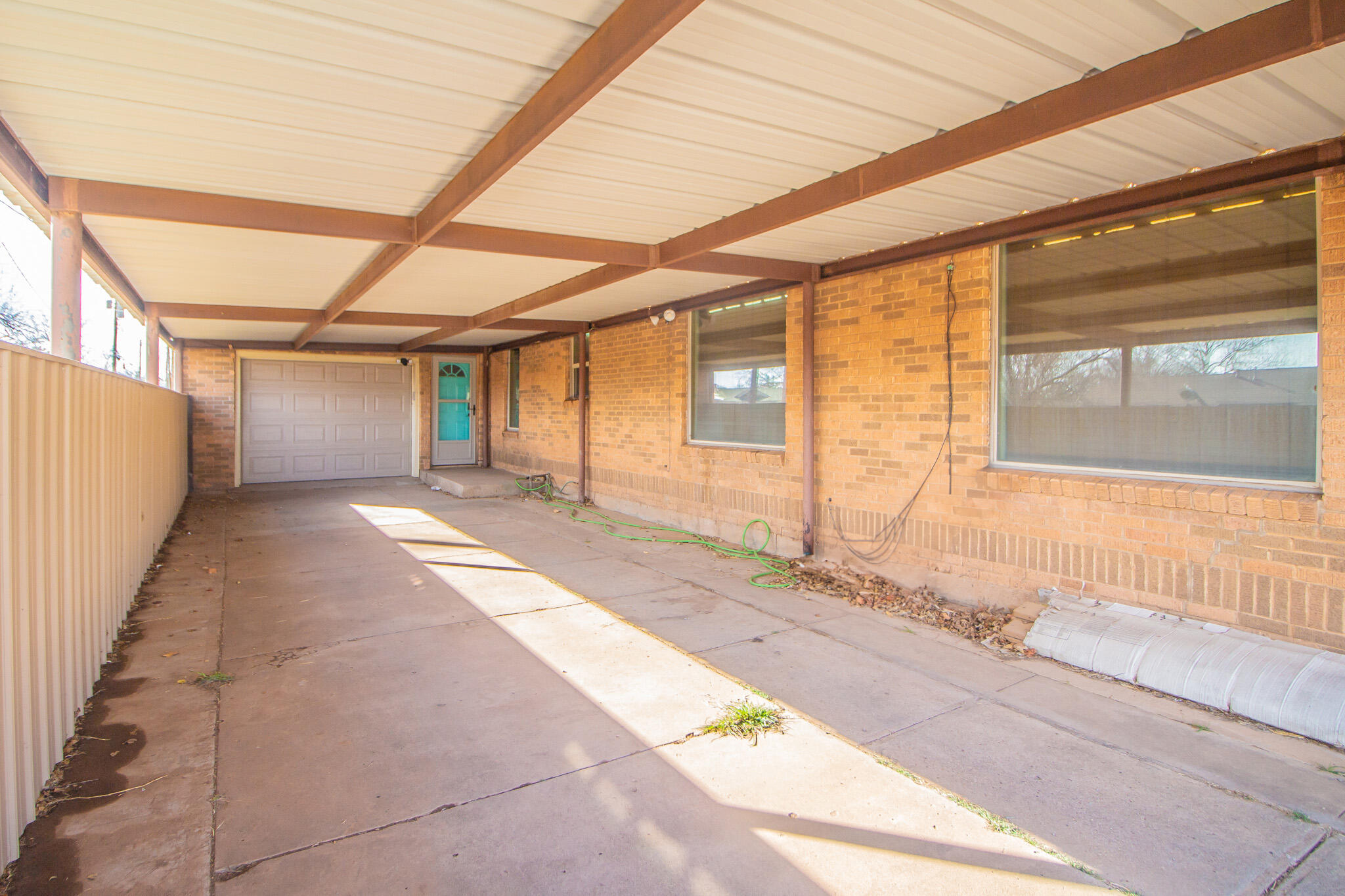 907 Ave H Hale Center, TX 79041 - Photo 4 of 32 a view of a large room with wooden floor and windows