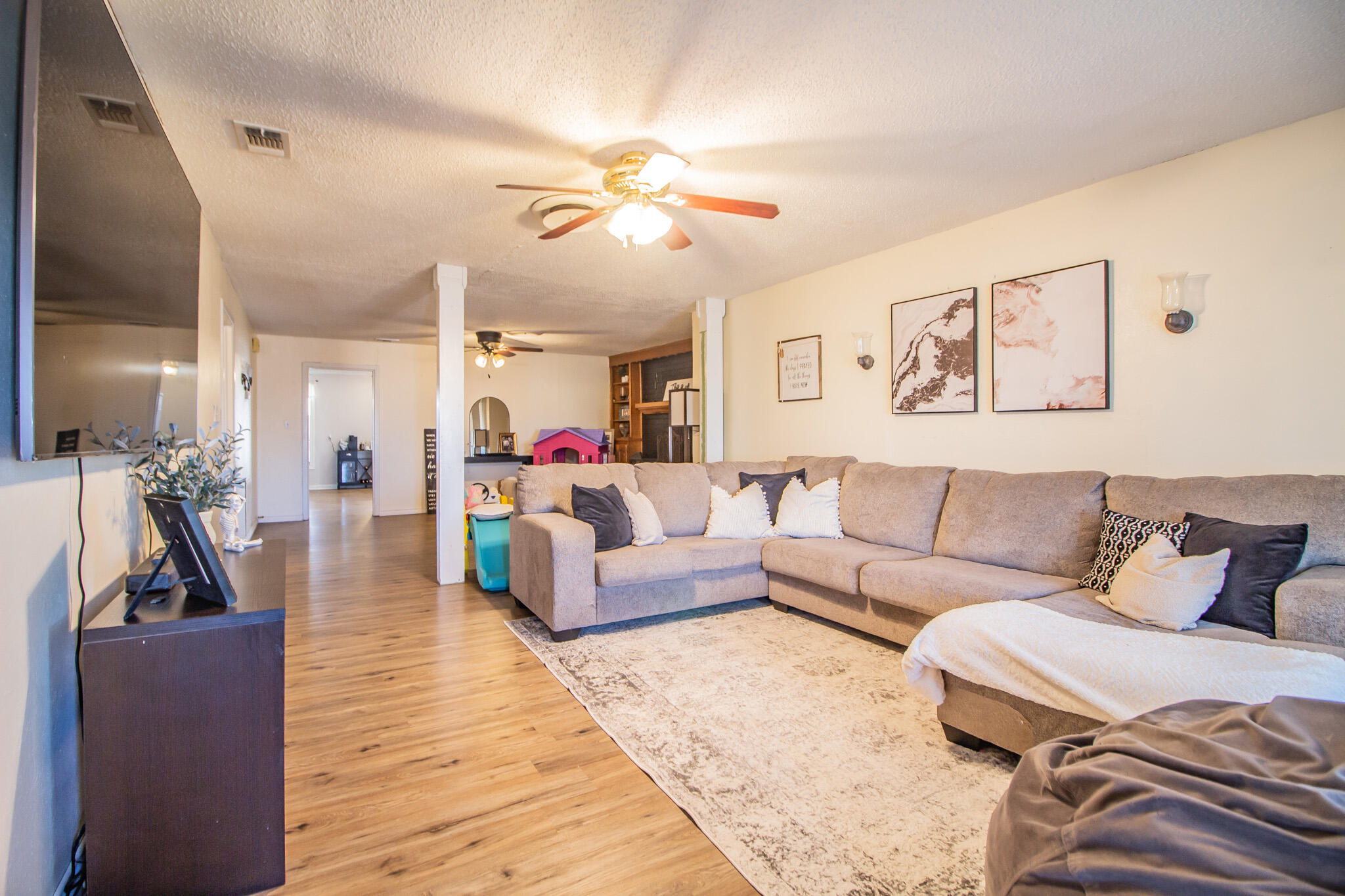 907 Ave H Hale Center, TX 79041 - Photo 5 of 32 a living room with furniture and wooden floor