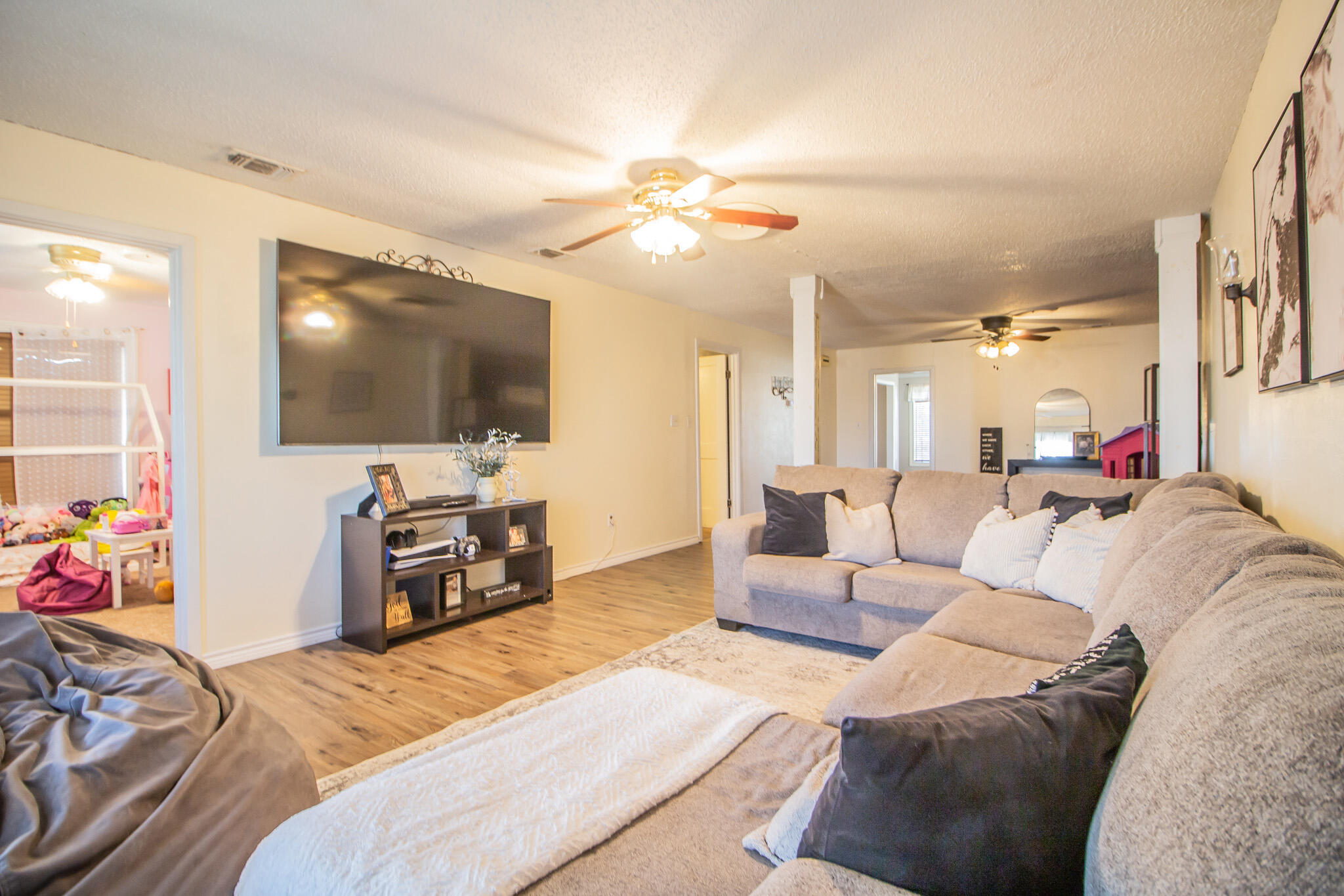 907 Ave H Hale Center, TX 79041 - Photo 6 of 32 a bedroom with furniture and a flat screen tv