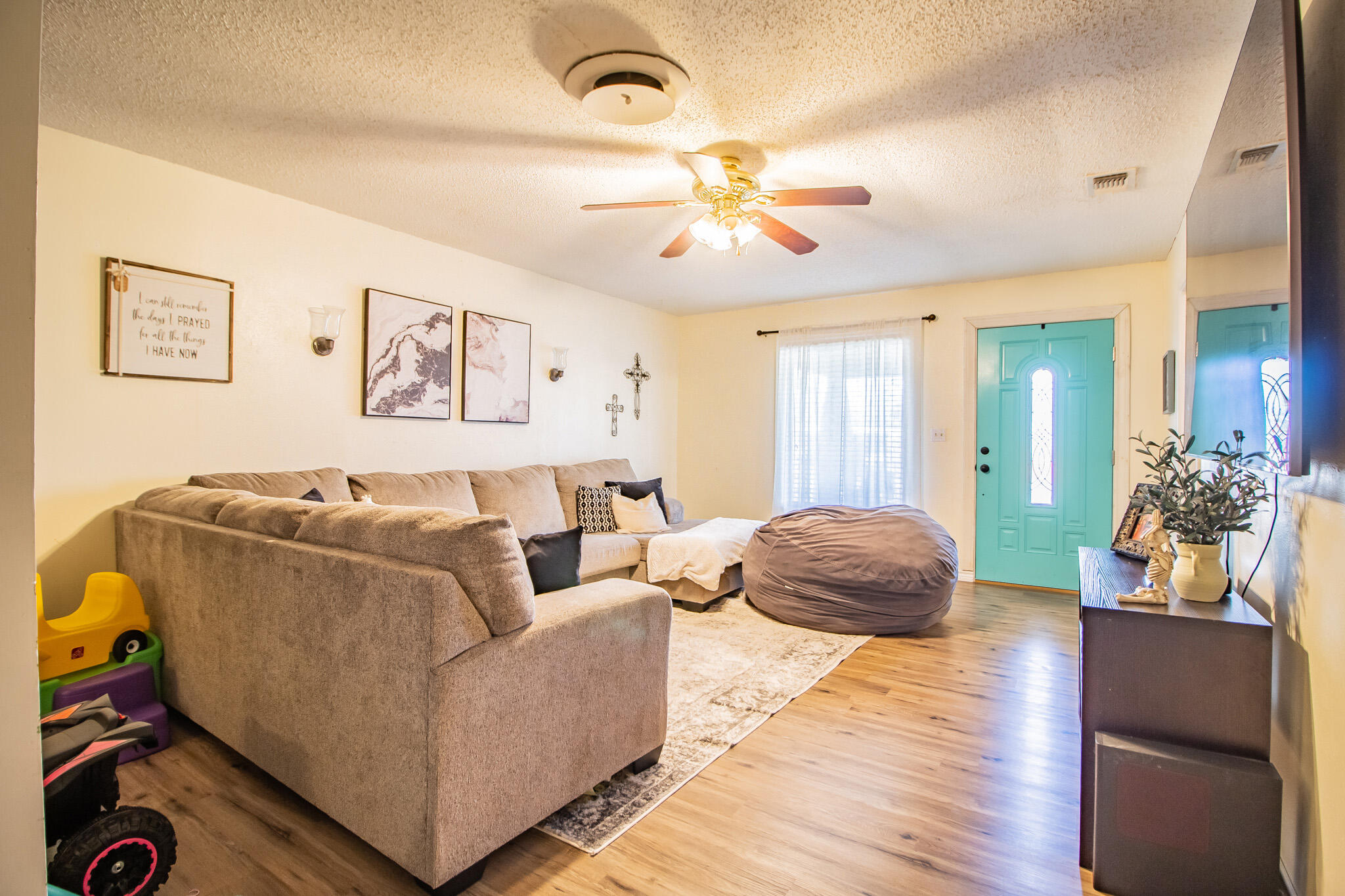 907 Ave H Hale Center, TX 79041 - Photo 7 of 32 a living room with furniture and wooden floor
