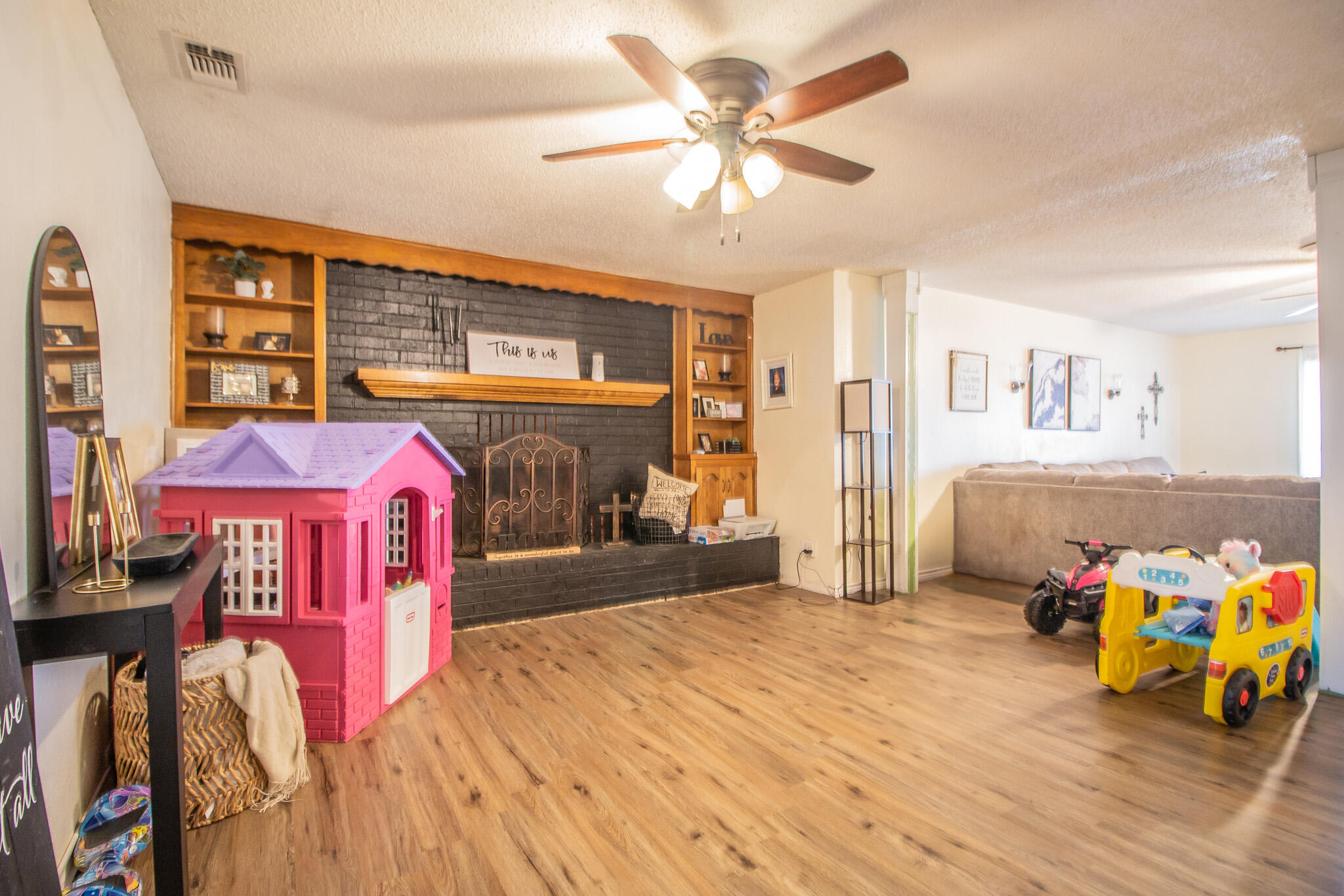 907 Ave H Hale Center, TX 79041 - Photo 8 of 32 a bedroom with a bed and a chandelier