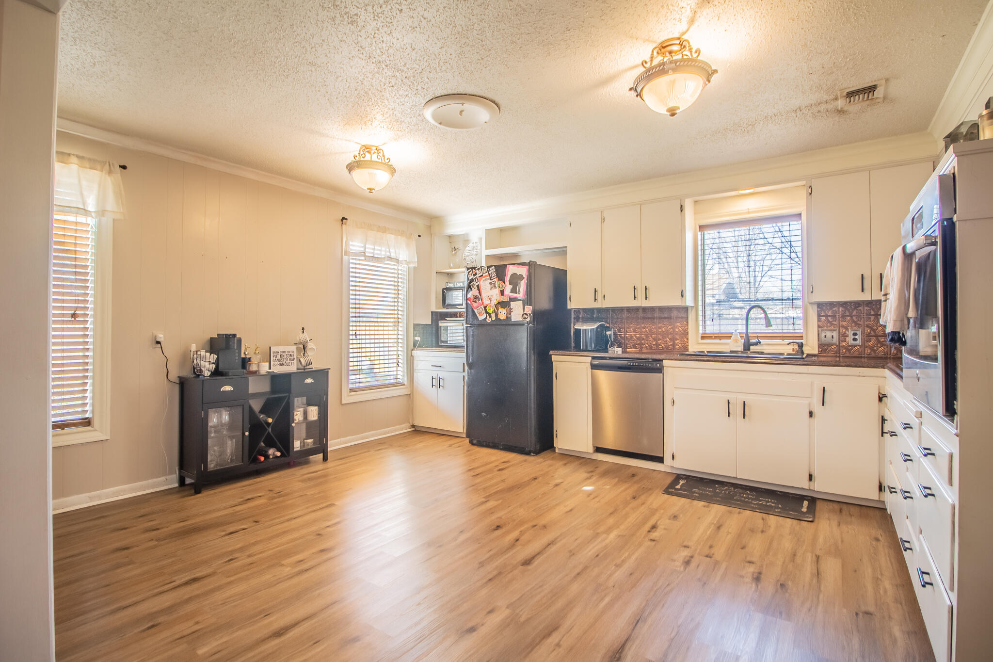 907 Ave H Hale Center, TX 79041 - Photo 10 of 32 a kitchen with stainless steel appliances wooden floors and wooden cabinets