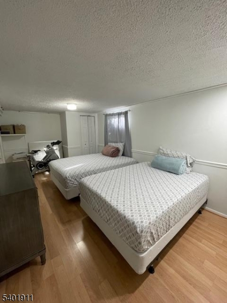 5 Wagon Wheel Road Vernon, NJ 07422 - Photo 6 of 8 a spacious bedroom with a bed and window