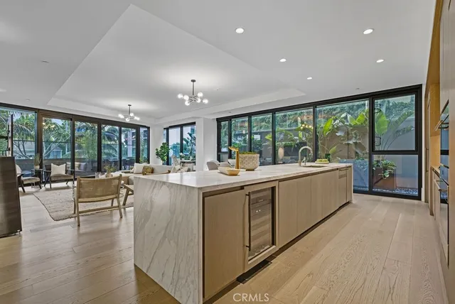 a living room with furniture and floor to ceiling window