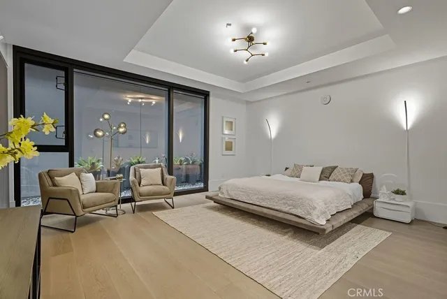 a bedroom with furniture and a chandelier