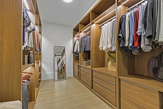 a bathroom with a granite countertop sink a mirror and shower