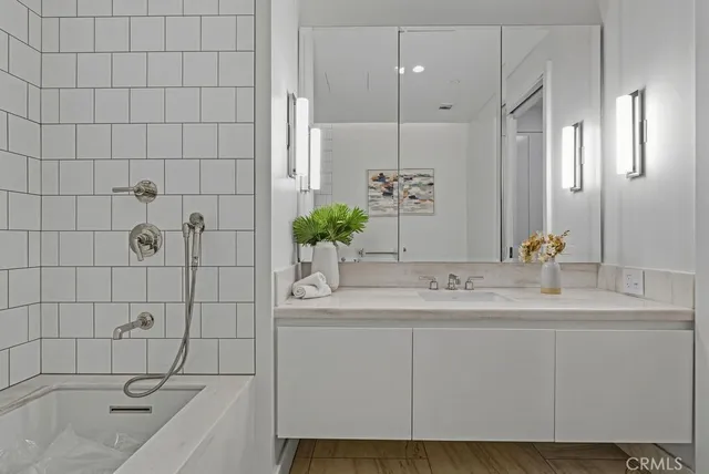 a bathroom with a sink vanity and a mirror