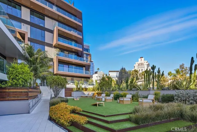 a view of a park with plants and palm trees