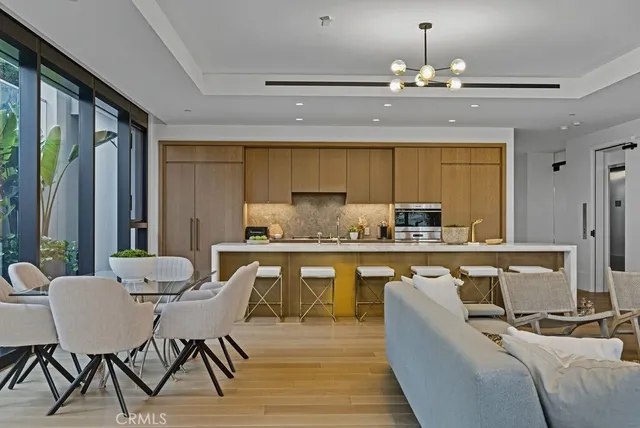 a kitchen with a table chairs stove and cabinets