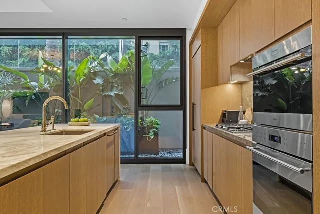 a kitchen with stainless steel appliances wooden cabinets and a stove
