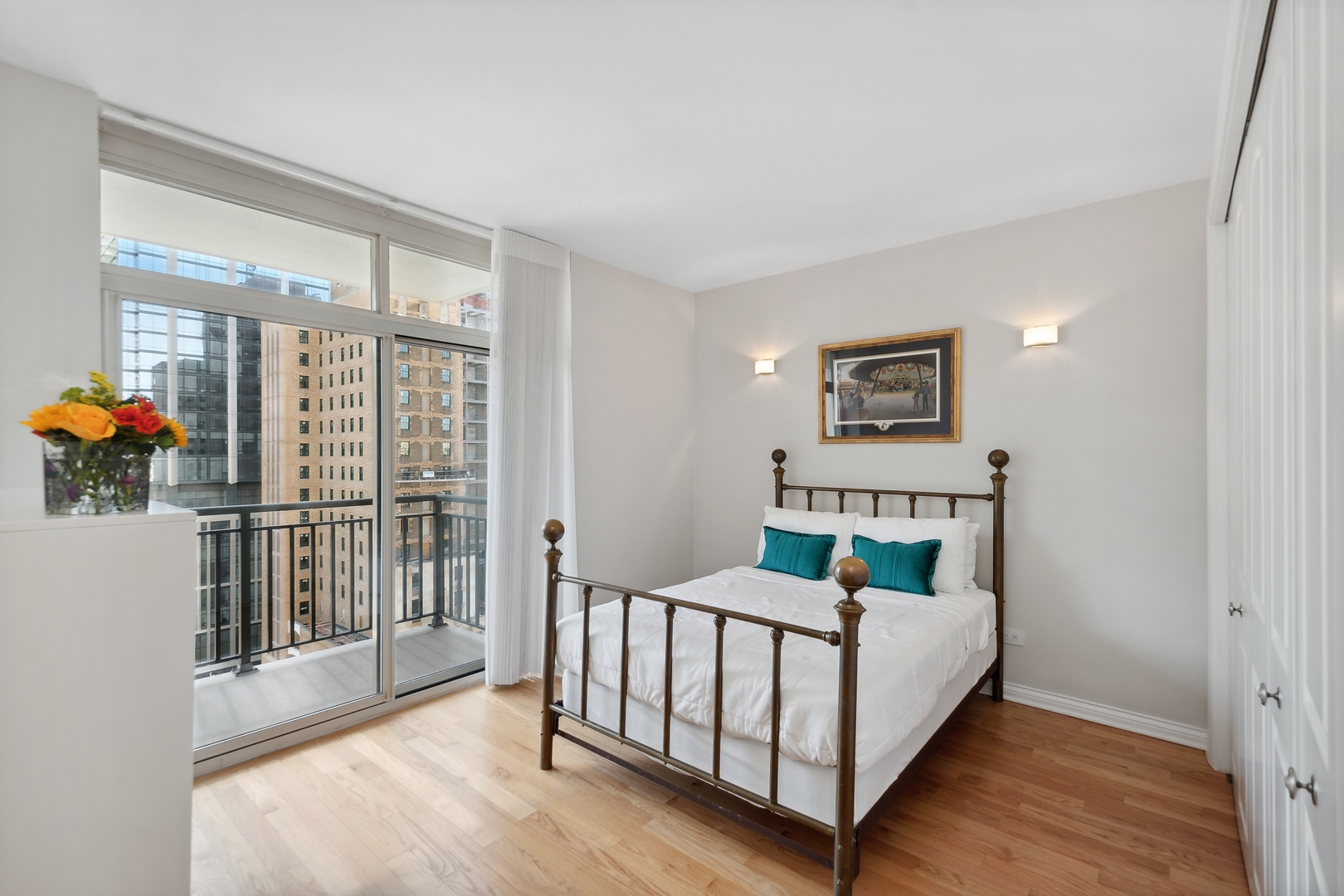 21 West Chestnut Street, Unit 1408 Chicago, IL 60610 - Photo 11 of 17 a bed sitting in a bedroom next to a window