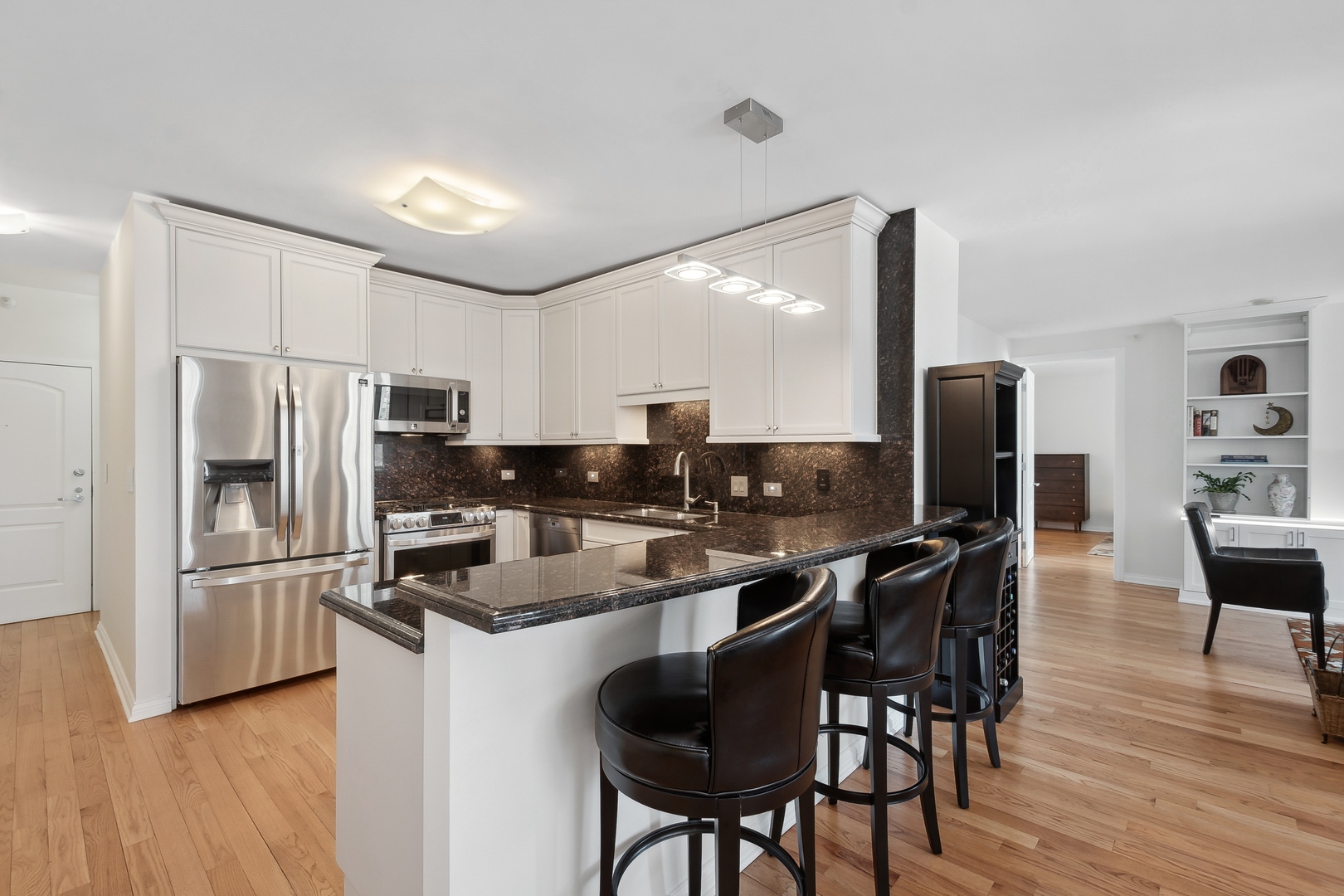 21 West Chestnut Street, Unit 1408 Chicago, IL 60610 - Photo 2 of 17 a kitchen with stainless steel appliances a refrigerator and a stove top oven