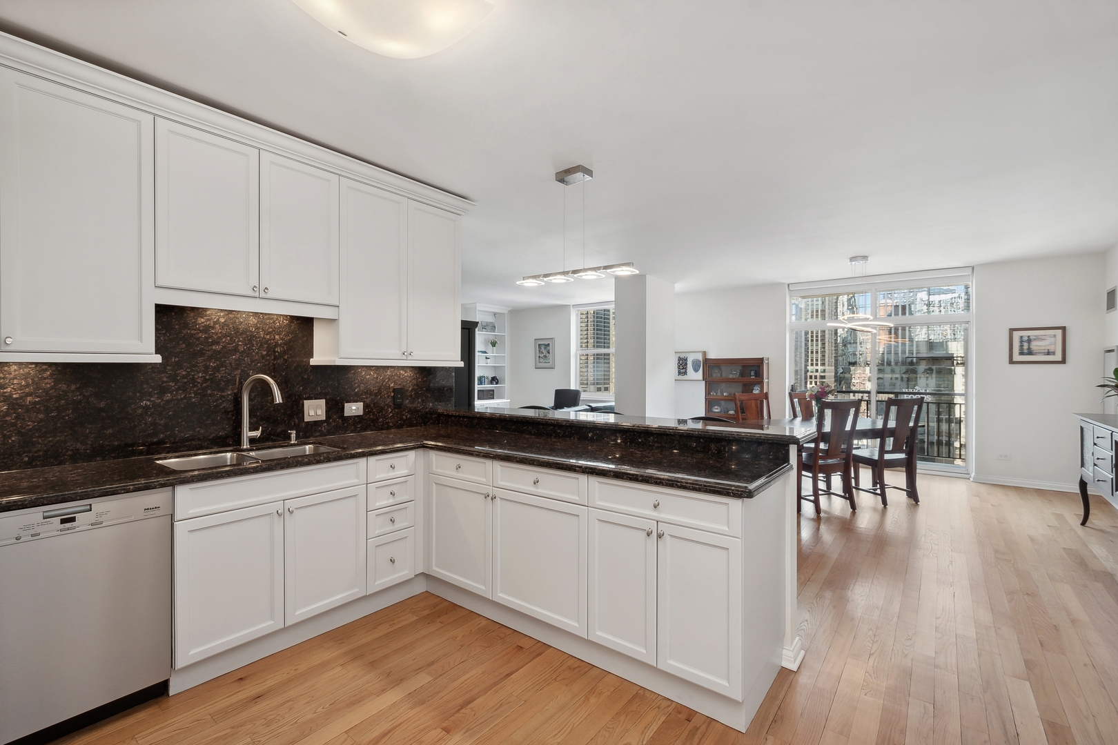 21 West Chestnut Street, Unit 1408 Chicago, IL 60610 - Photo 3 of 17 a kitchen with granite countertop a sink and cabinets