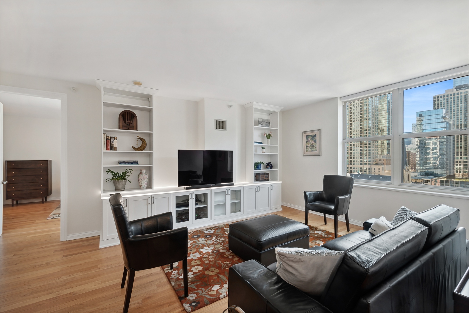 21 West Chestnut Street, Unit 1408 Chicago, IL 60610 - Photo 4 of 17 a living room with furniture and a flat screen tv
