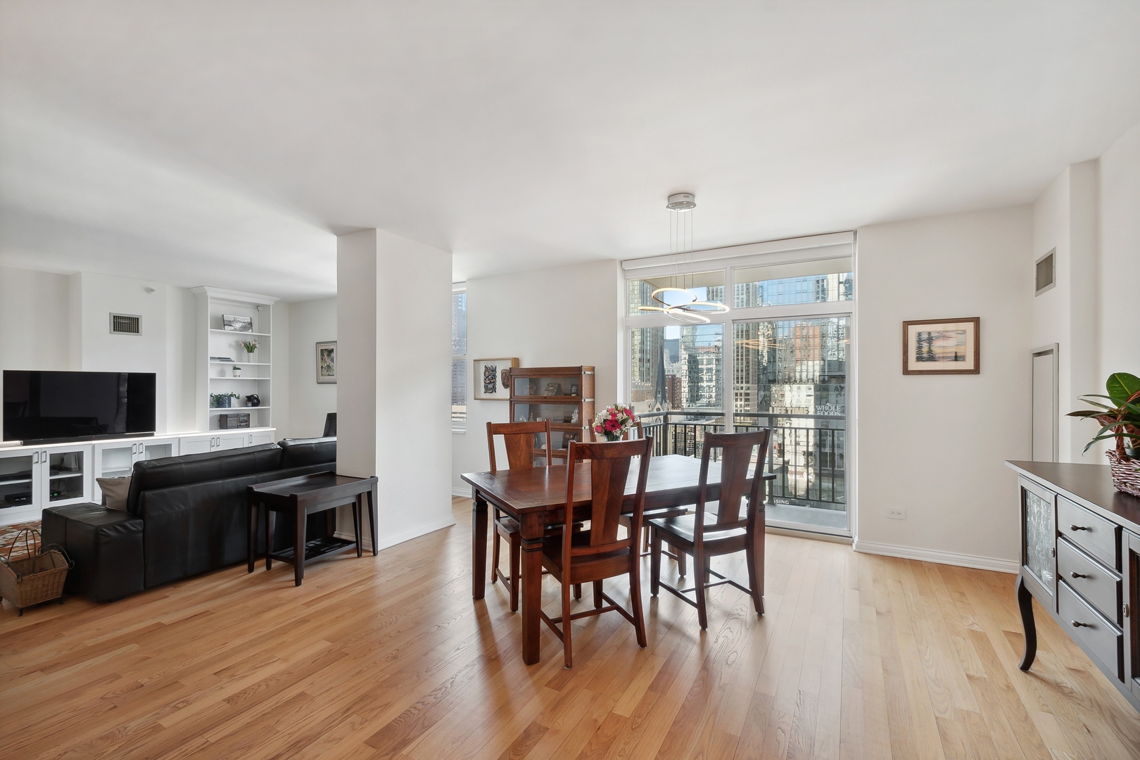 21 West Chestnut Street, Unit 1408 Chicago, IL 60610 - Photo 6 of 17 a view of a dining room with furniture and wooden floor
