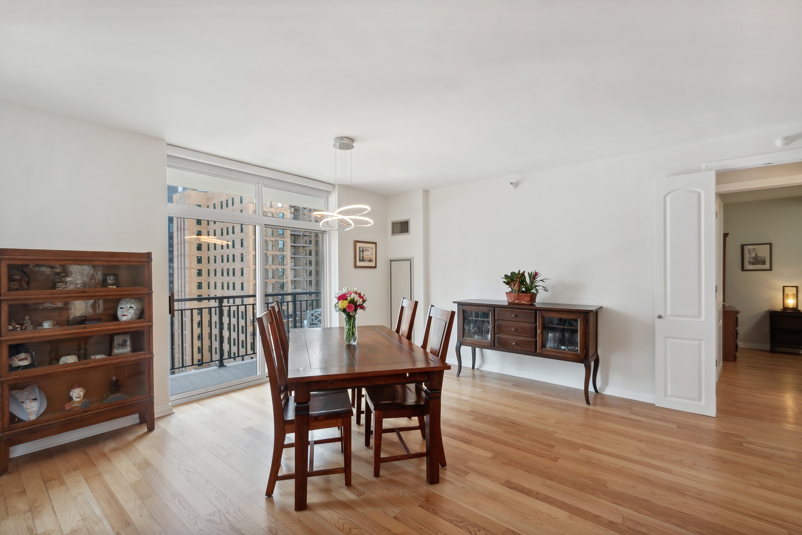 21 West Chestnut Street, Unit 1408 Chicago, IL 60610 - Photo 7 of 17 a view of a dining room with furniture and wooden floor